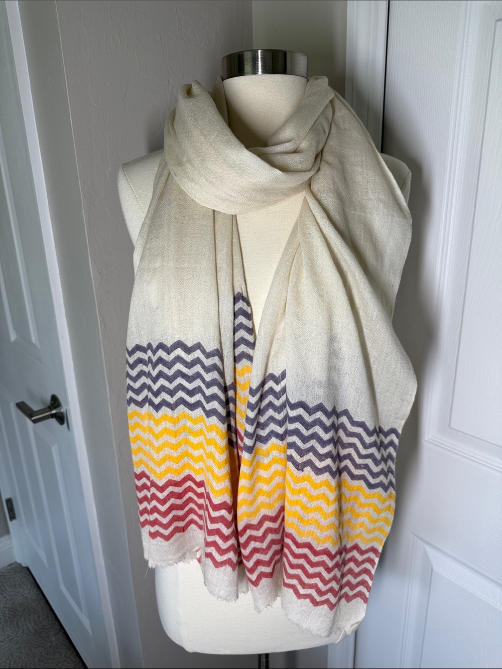 Cashmere ivory red, yellow, and blue zigzag stripe scarf.